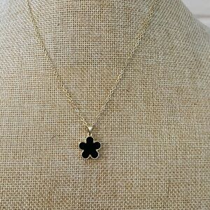 Fashion, unbranded single black clover necklace on gold-plated necklace.